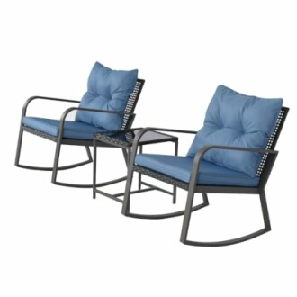 Two blue cushion patio rocking chairs with a small table in between.