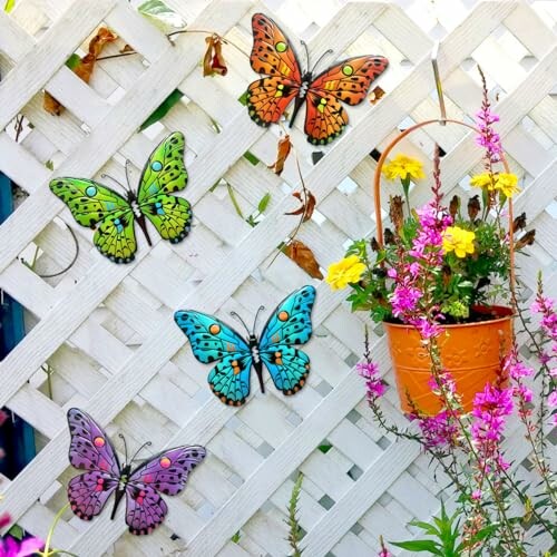 Colorful metal butterflies on a white lattice with hanging flowers.