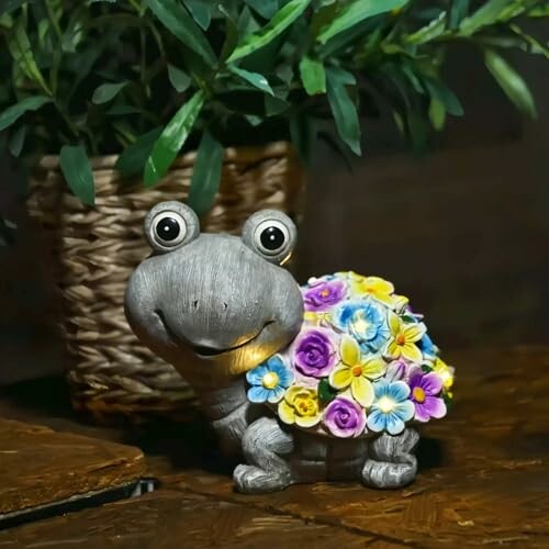 Adorable turtle figurine with colorful flowers on its back, next to a plant in a woven basket.