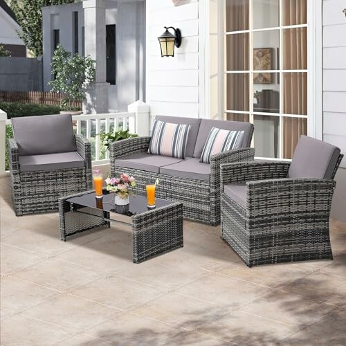 Outdoor patio furniture set with chairs, loveseat, and table.