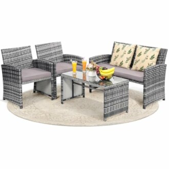 Outdoor patio furniture set with chairs, loveseat, table, and decor.