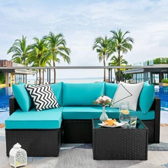 Outdoor patio furniture set by a pool with palm trees